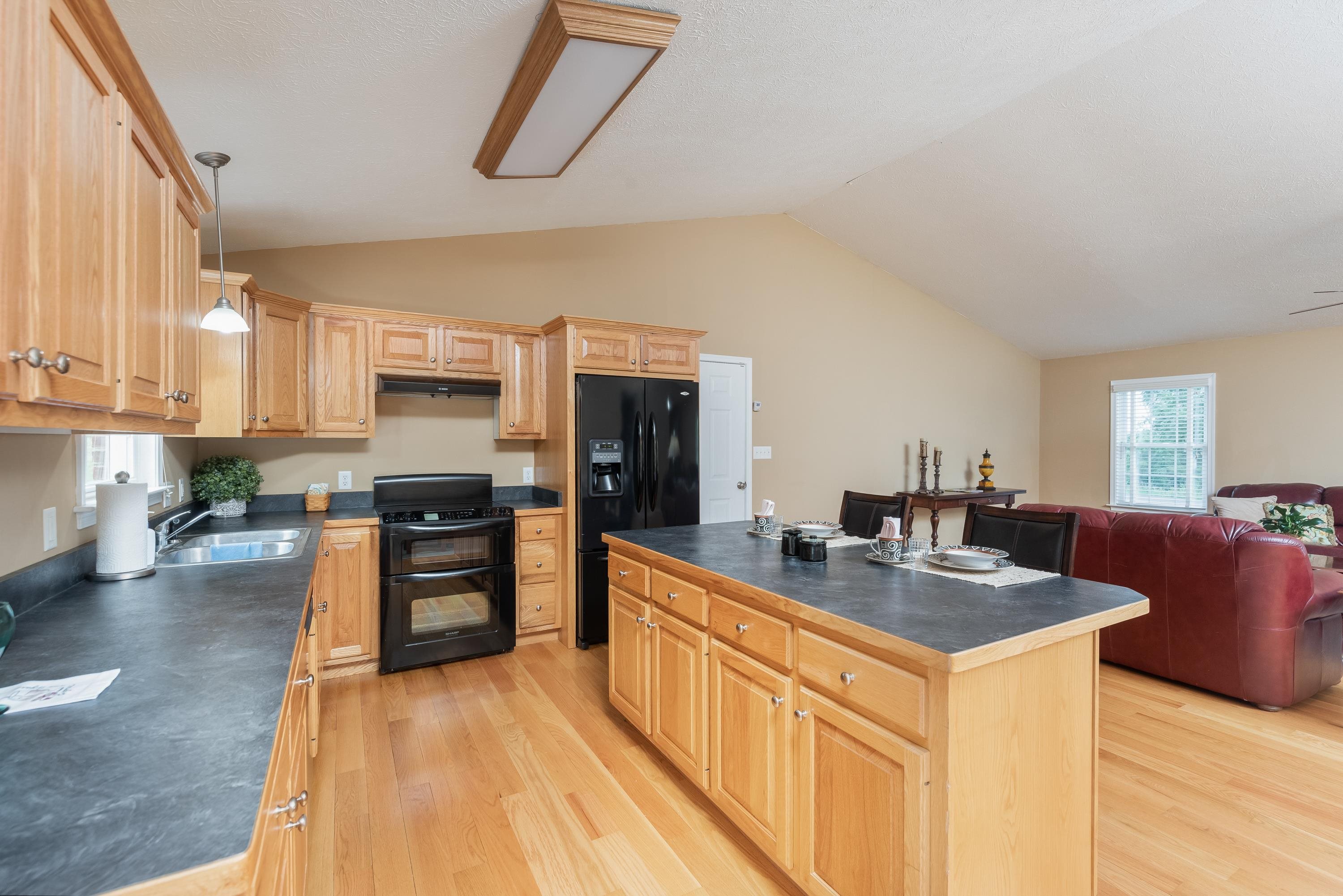 3934 Shutterlee Mill Road Staunton, VA 24401 - Photo 15 of 49 a kitchen with stainless steel appliances granite countertop a sink stove and refrigerator