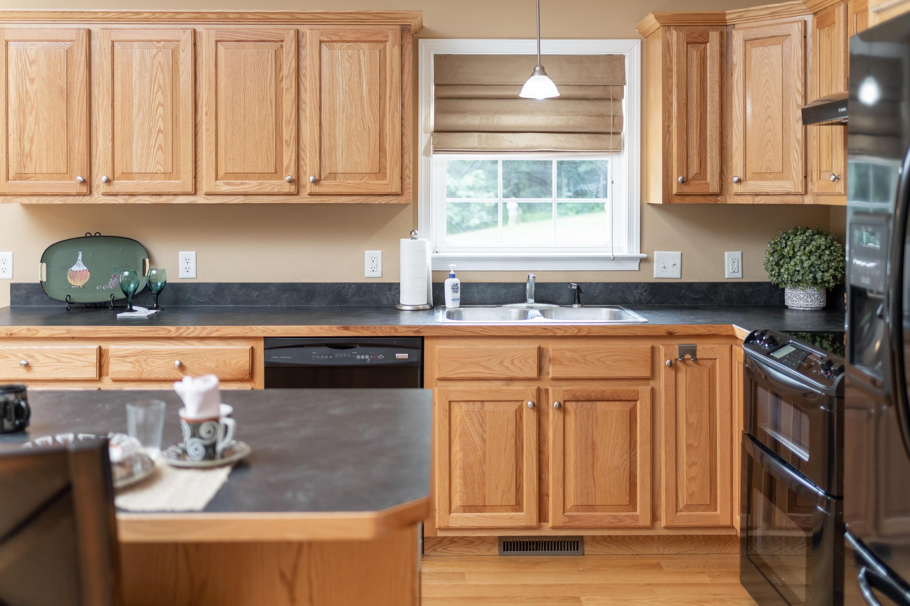 3934 Shutterlee Mill Road Staunton, VA 24401 - Photo 17 of 49 a kitchen with stainless steel appliances granite countertop a stove and a white cabinets