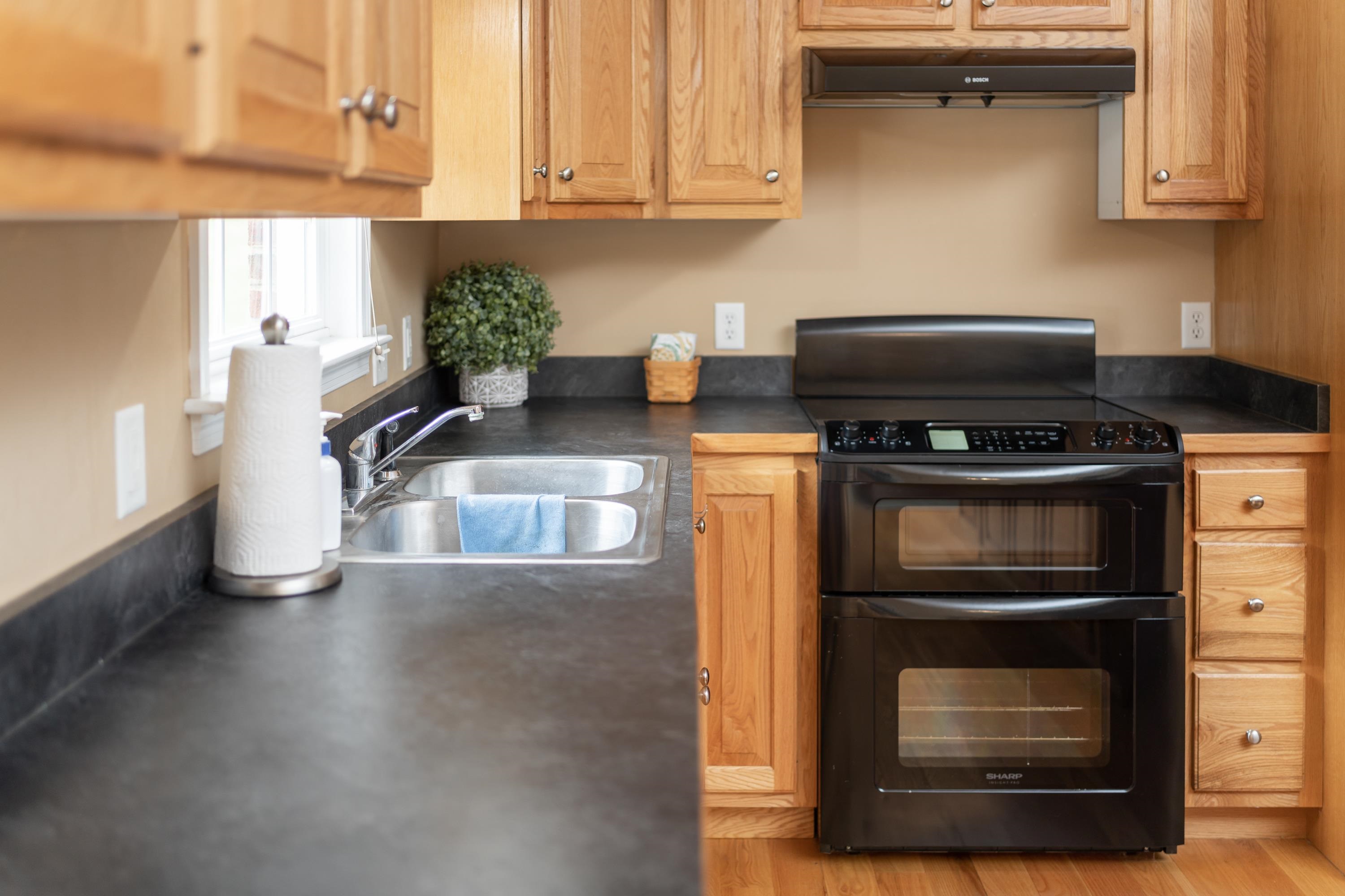 3934 Shutterlee Mill Road Staunton, VA 24401 - Photo 18 of 49 a kitchen with stainless steel appliances granite countertop a stove a microwave and a refrigerator