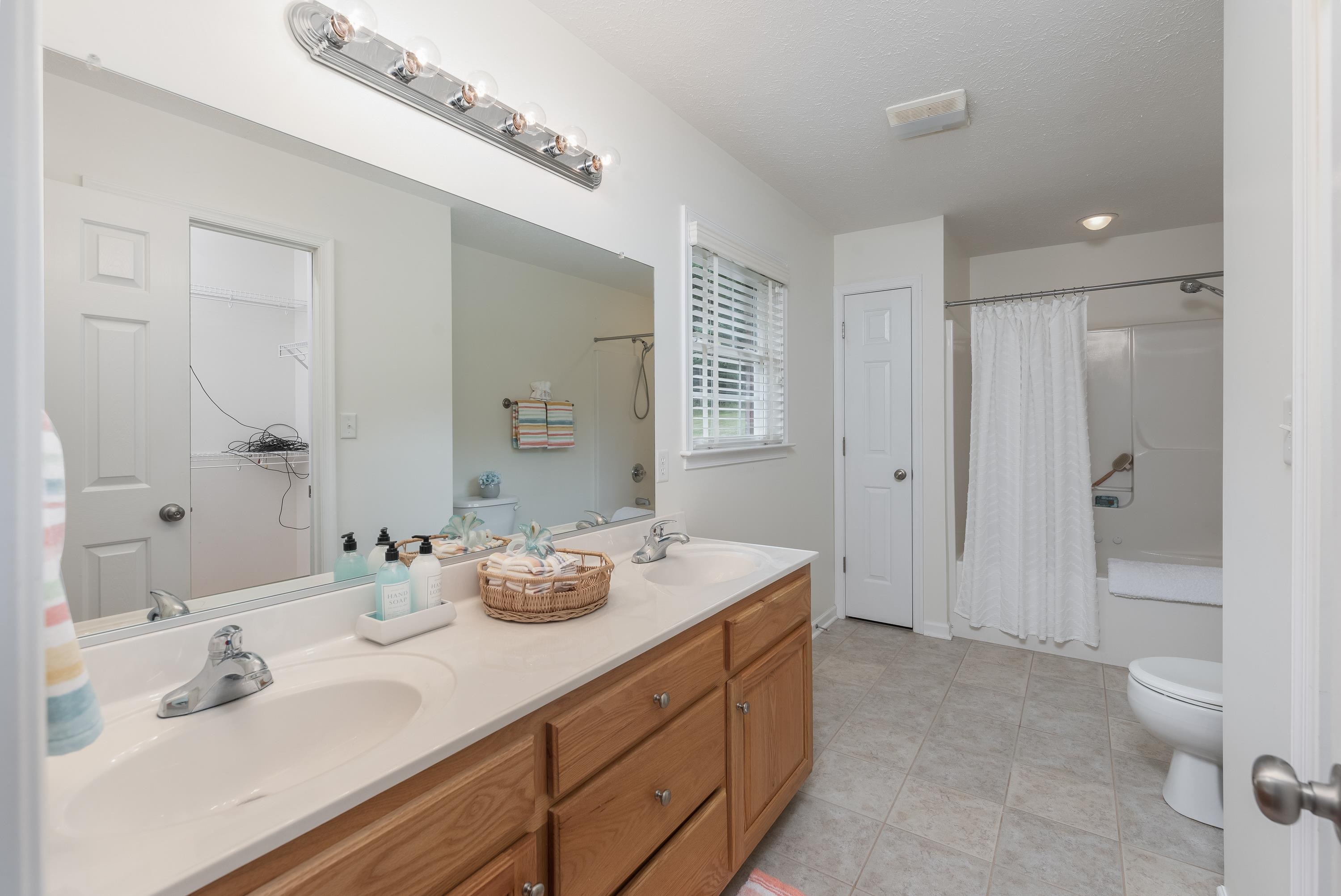 3934 Shutterlee Mill Road Staunton, VA 24401 - Photo 24 of 49 a spacious bathroom with a granite countertop sink toilet and shower