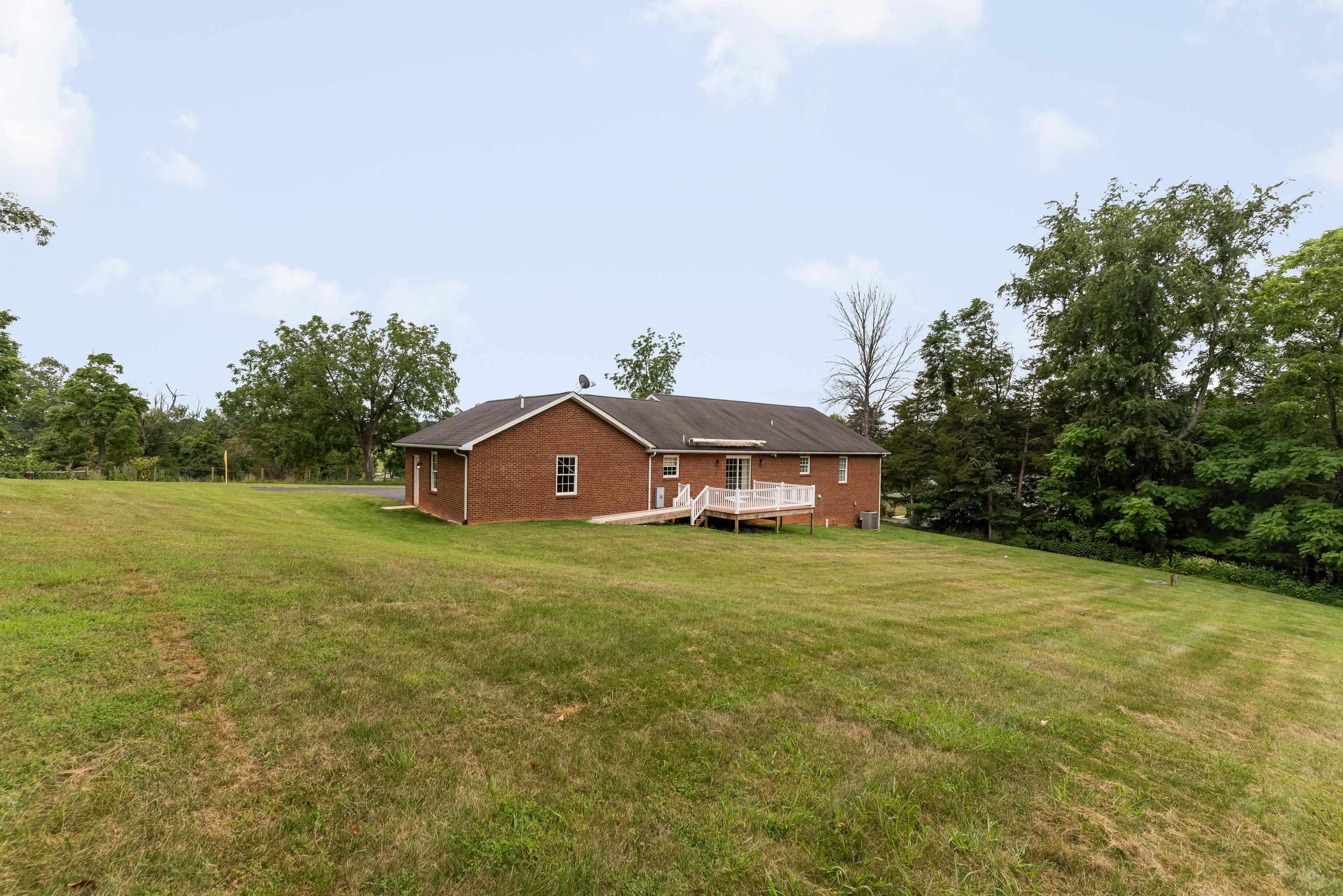3934 Shutterlee Mill Road Staunton, VA 24401 - Photo 45 of 49 a yellow house with a big yard and large trees