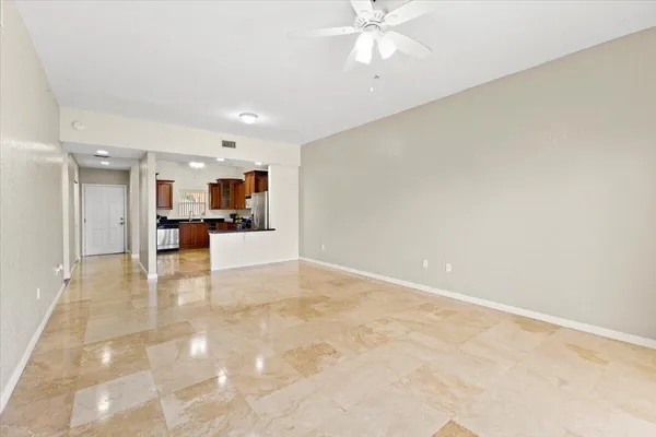 a view of a livingroom with furniture and a kitchen view