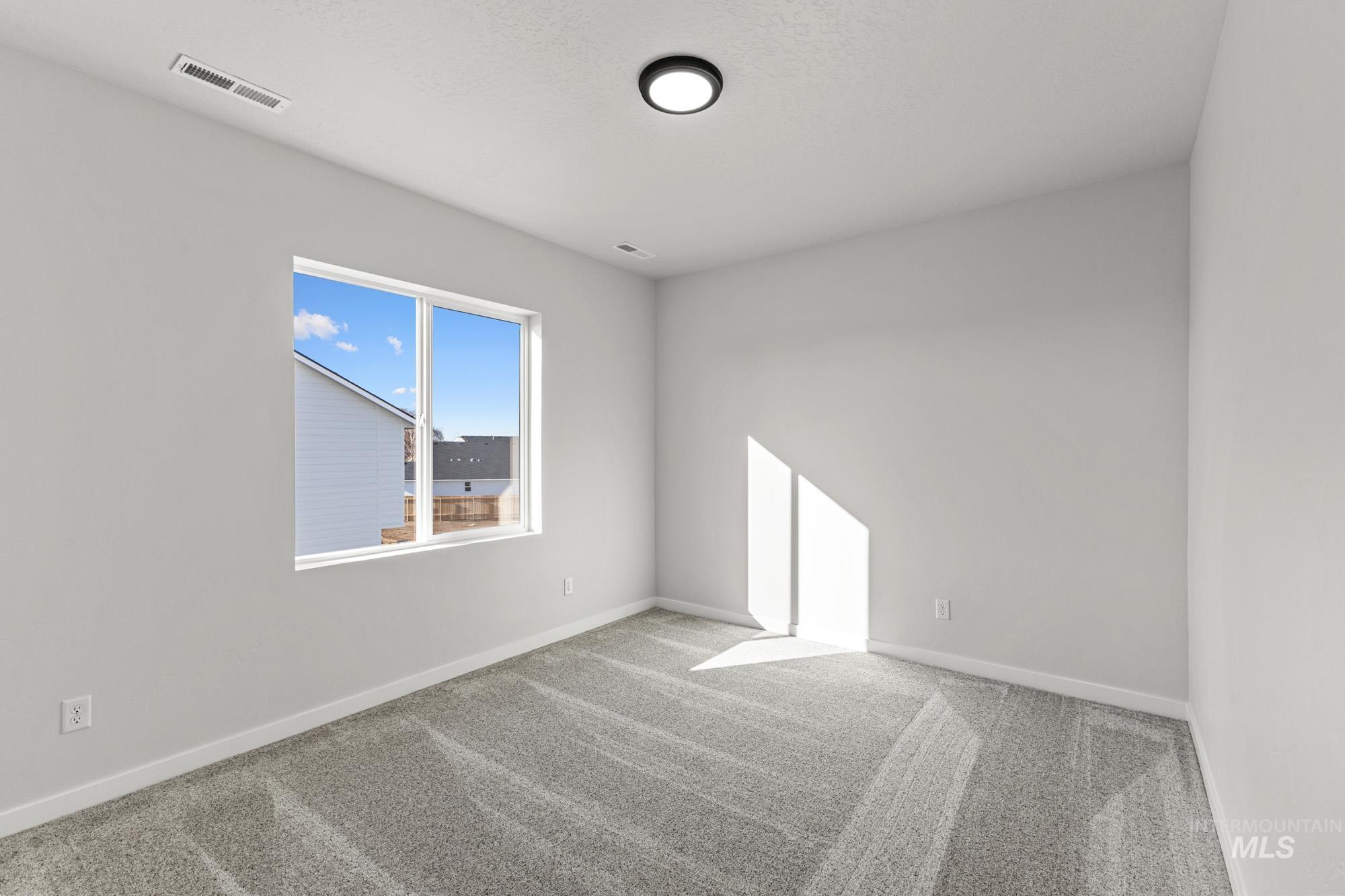 13708 Judson Street Caldwell, ID 83607 - Photo 17 of 29 Empty room featuring carpet flooring and baseboards