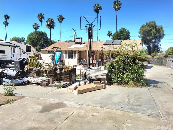 a view of a house with a yard and sitting area