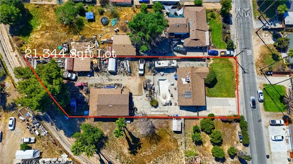 an aerial view of a house with a yard and garden