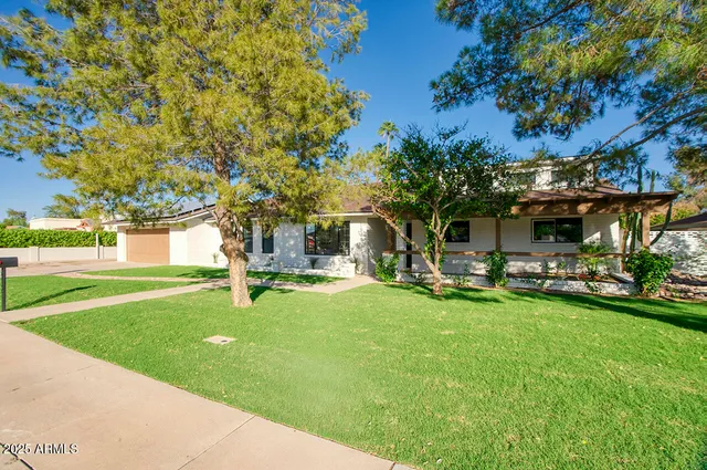 a swimming pool with outdoor seating and yard
