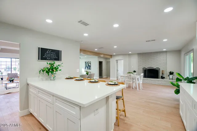 a view of kitchen with sink refrigerator and dining table