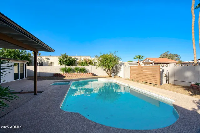 a view of a swimming pool with a patio