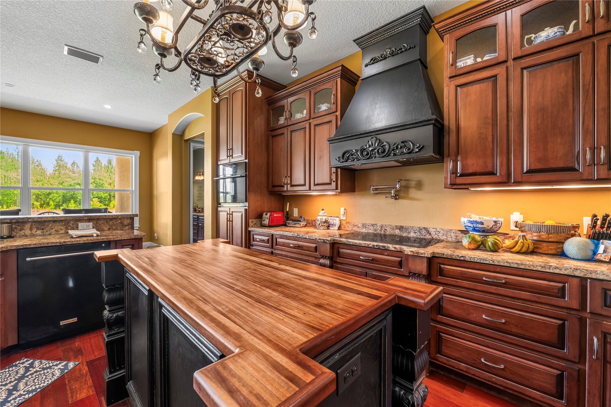 27247 Hallman Road Hilliard, FL 32046 - Photo 23 of 59 a kitchen with stainless steel appliances granite countertop a stove a sink and a microwave