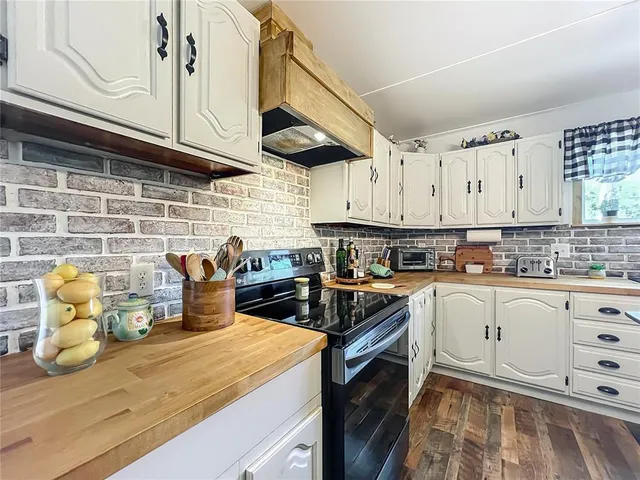 a living room with a table chairs and wooden floor