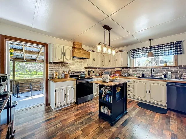 a dining room with furniture a potted plant and a chandelier