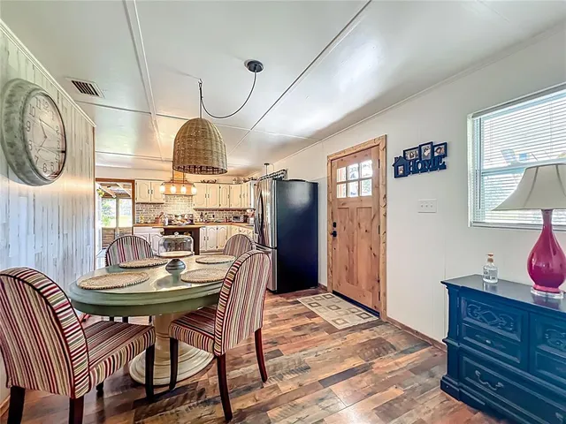 a spacious bedroom with a bed and a chandelier