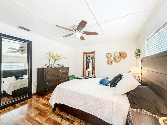 a bedroom with a bed and a book shelf