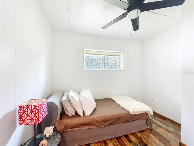 an aerial view of residential houses with outdoor space and trees