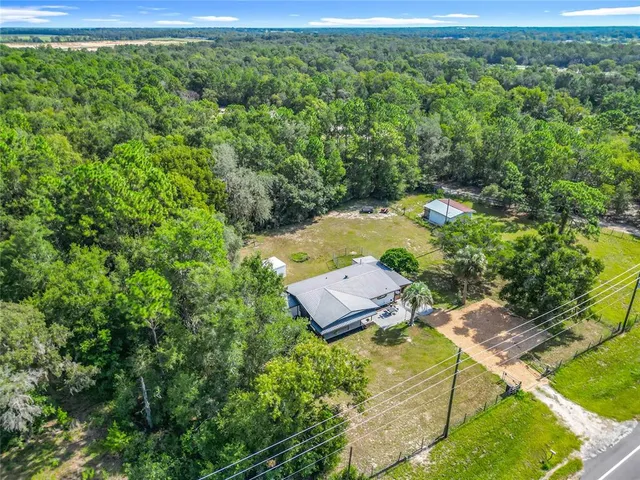 an aerial view of a house with a yard
