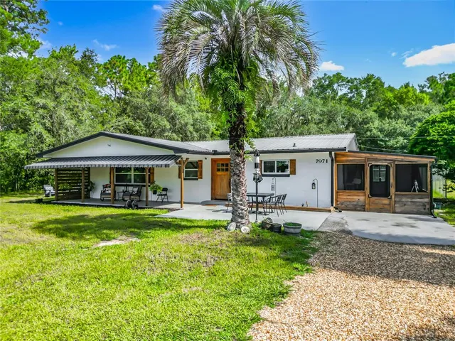 a house view with swimming pool and wooden fence