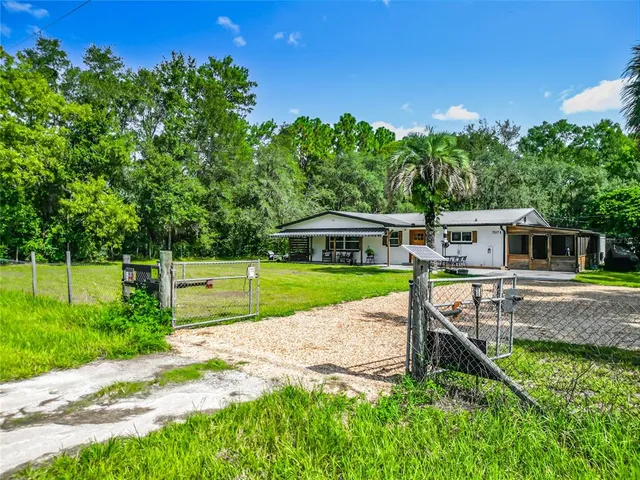 an aerial view of a house with swimming pool garden and patio