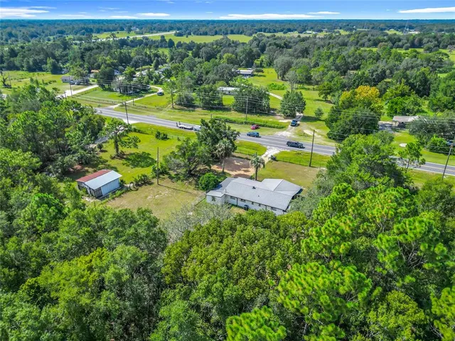 a view of a house with a backyard