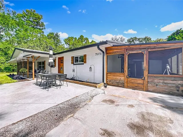 a kitchen with a sink cabinets stainless steel appliances and wooden floor