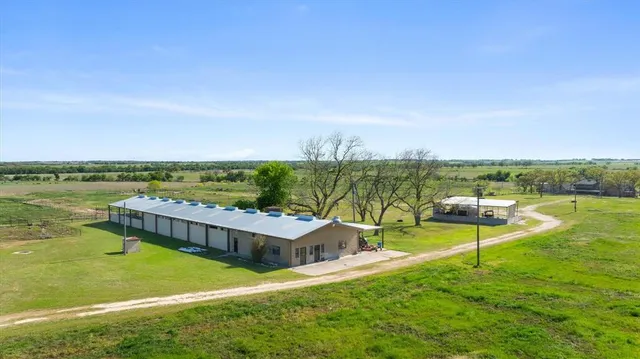 an aerial view of a house with a garden and lake view