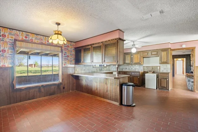 a kitchen with stainless steel appliances kitchen island granite countertop a sink and cabinets