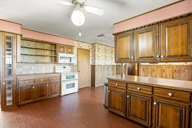 a kitchen with stainless steel appliances granite countertop a stove and cabinets