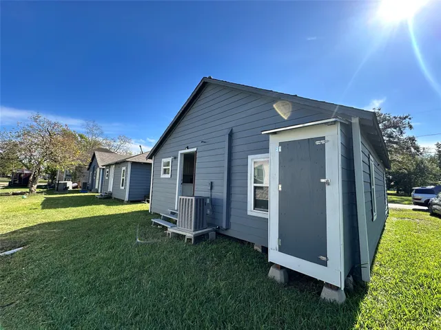 a backyard of a house with table and chairs