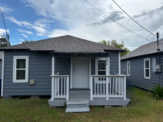 a view of a house with a small deck