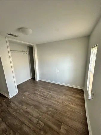 a view of an empty room and wooden floor