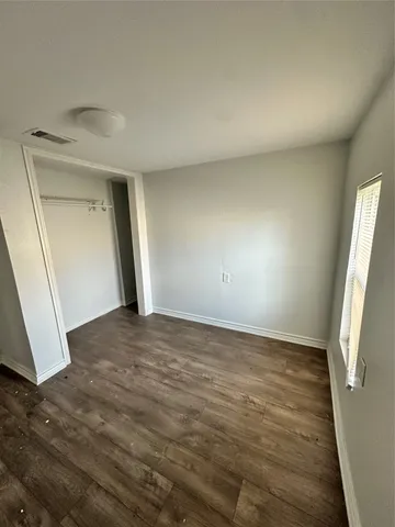 a view of an empty room and wooden floor