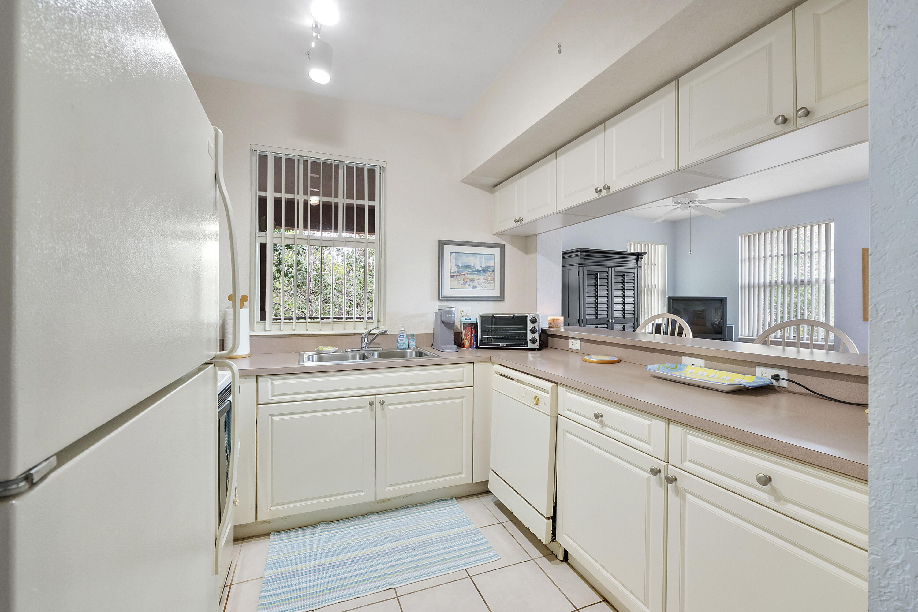 6592 West Sample Road, Unit 6592 Coral Springs, FL 33067 - Photo 13 of 42 a kitchen with a sink and cabinets