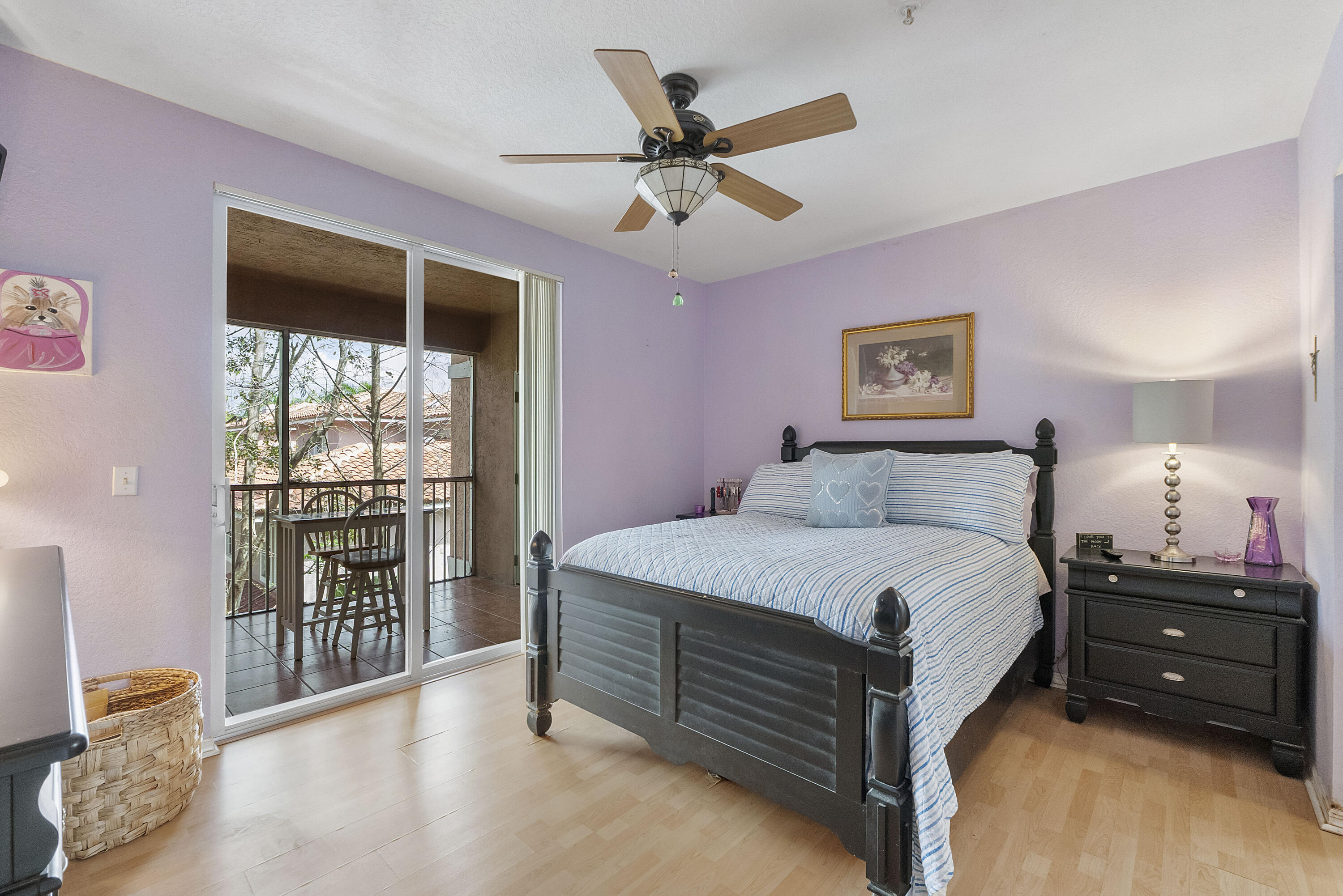 6592 West Sample Road, Unit 6592 Coral Springs, FL 33067 - Photo 19 of 42 a spacious bedroom with a bed a dresser and a chandelier