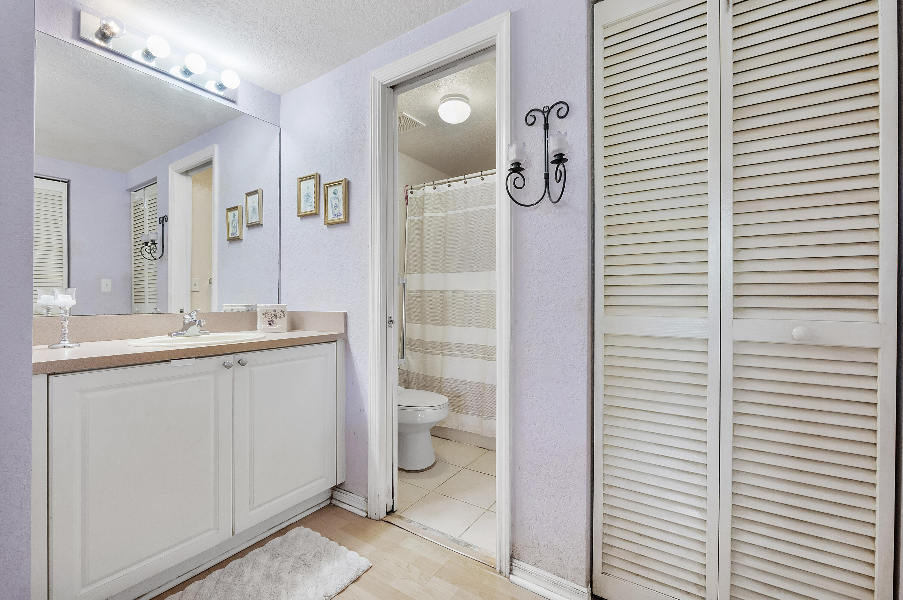 6592 West Sample Road, Unit 6592 Coral Springs, FL 33067 - Photo 21 of 42 a bathroom with a granite countertop sink toilet and shower