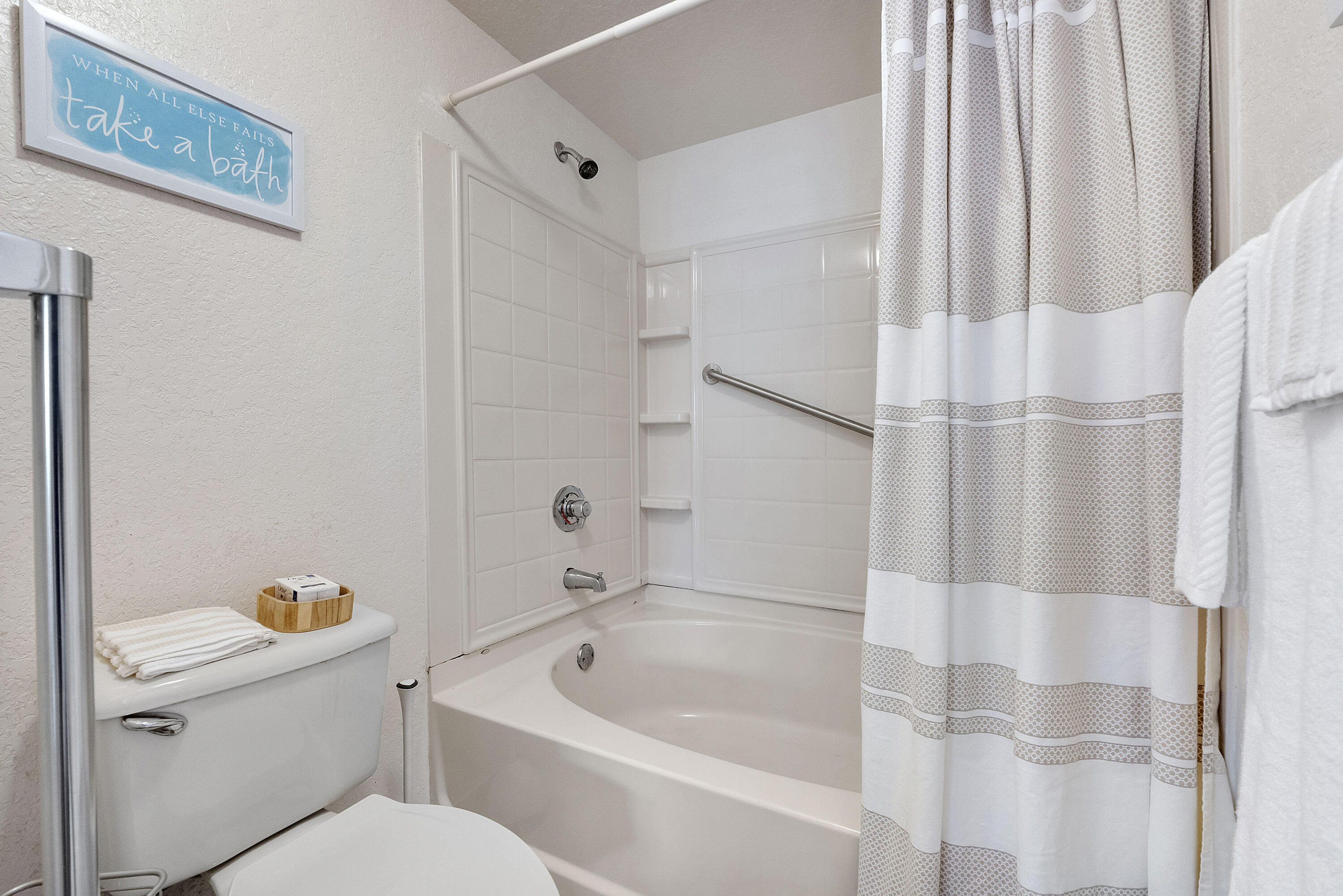 6592 West Sample Road, Unit 6592 Coral Springs, FL 33067 - Photo 23 of 42 a white bath tub sitting next to a white toilet and sink
