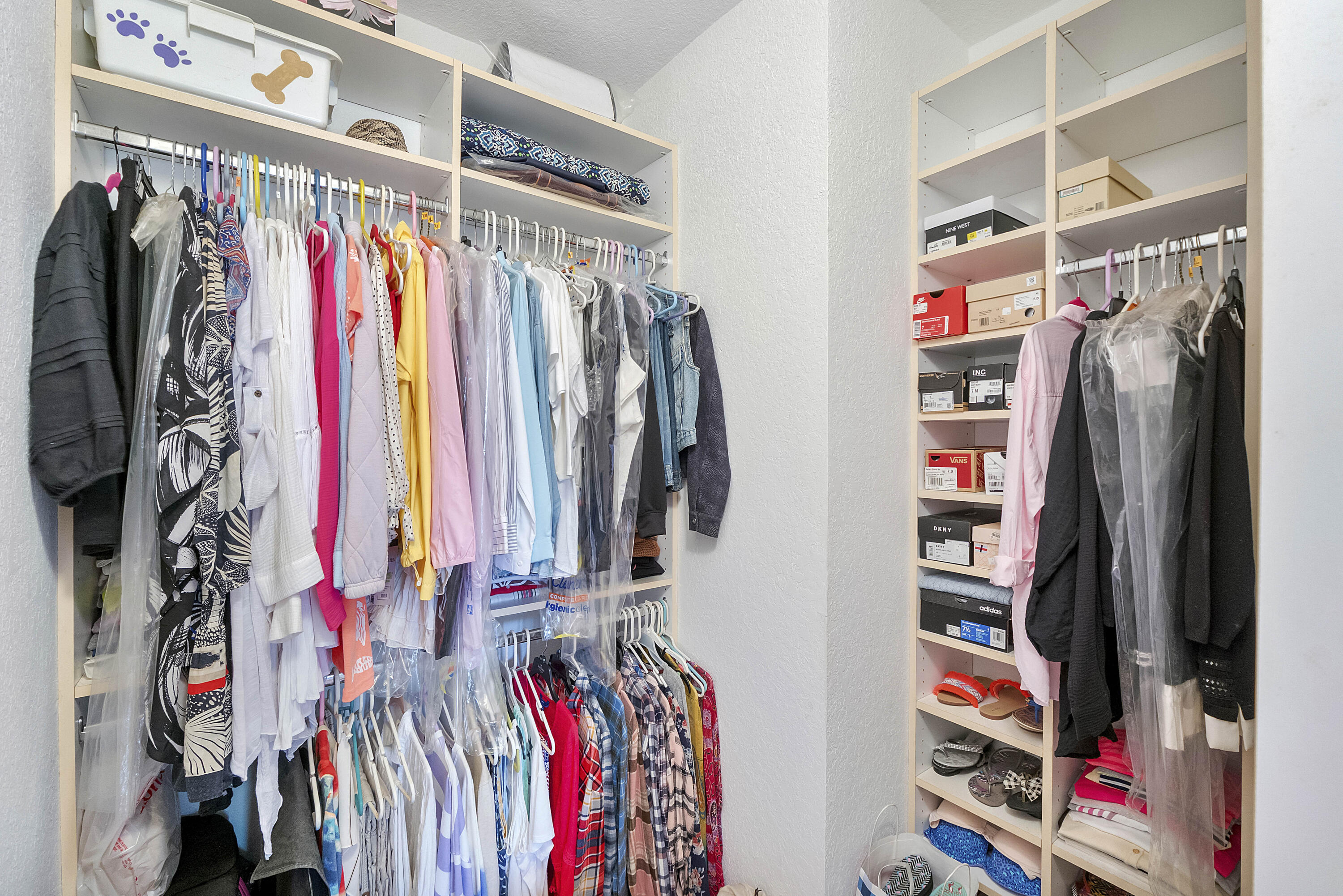 6592 West Sample Road, Unit 6592 Coral Springs, FL 33067 - Photo 24 of 42 a view of walk in closet with clothes and shoes