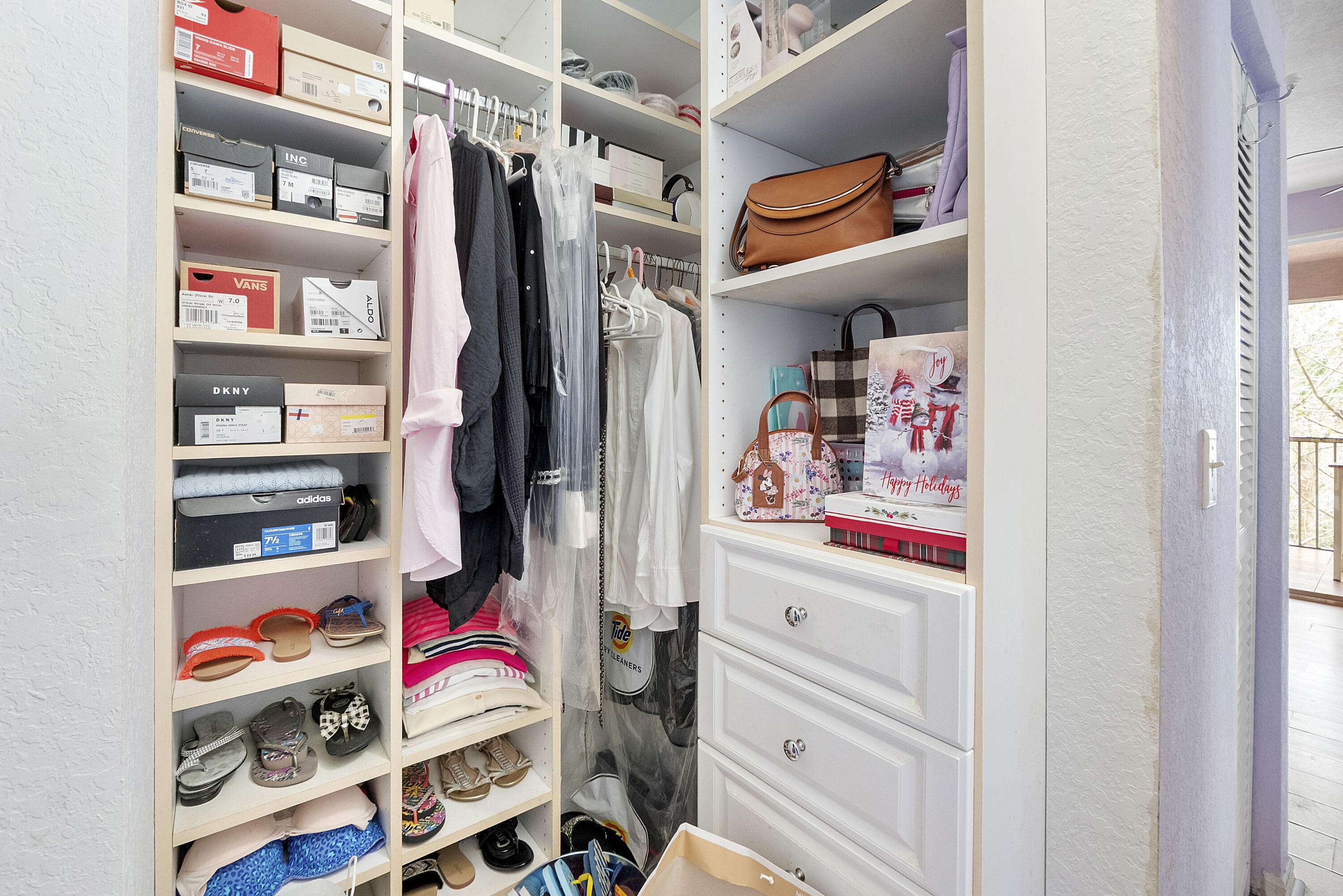 6592 West Sample Road, Unit 6592 Coral Springs, FL 33067 - Photo 25 of 42 a view of walk in closet with clothes and shoes
