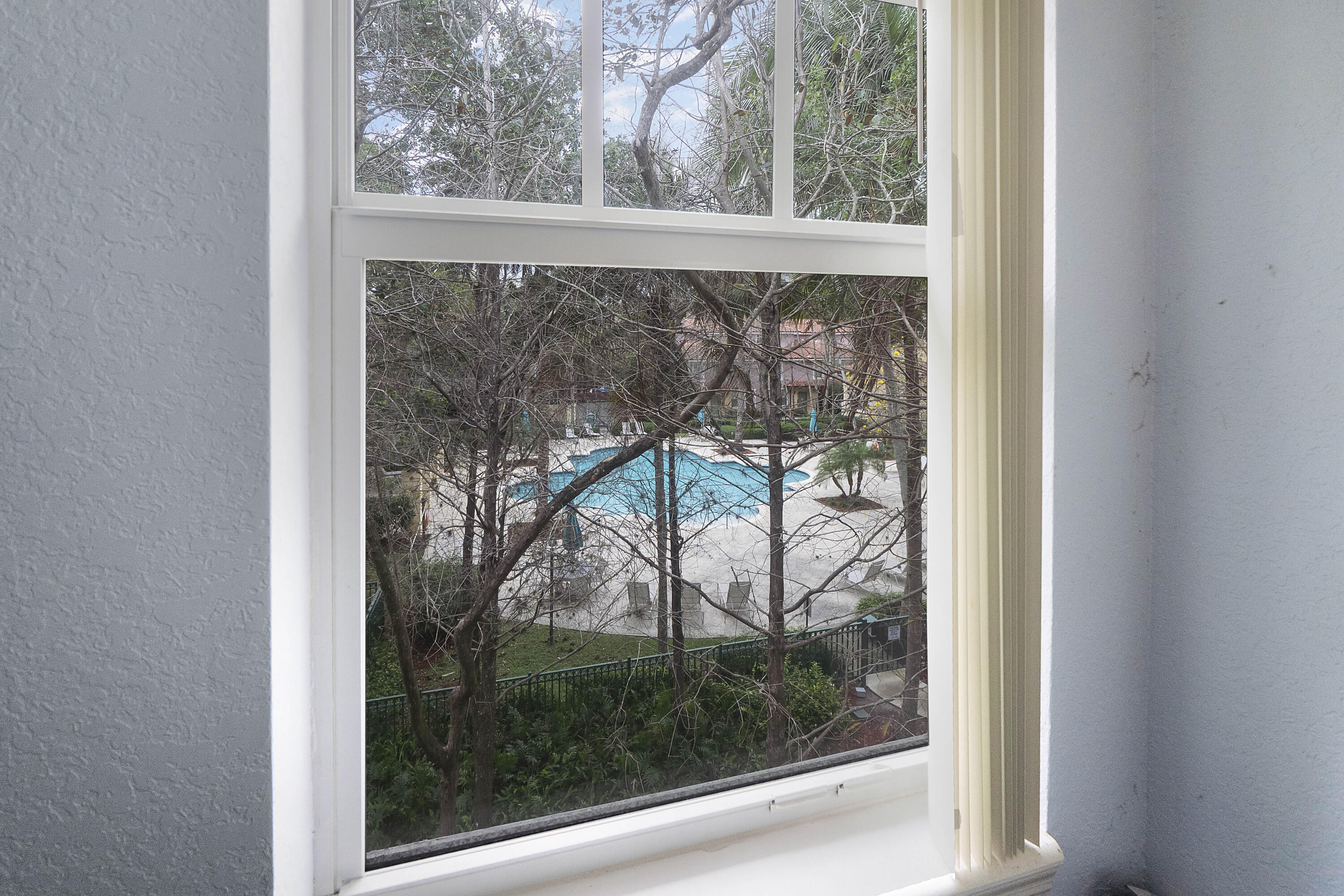 6592 West Sample Road, Unit 6592 Coral Springs, FL 33067 - Photo 27 of 42 a view of a room with a large window and wooden floor