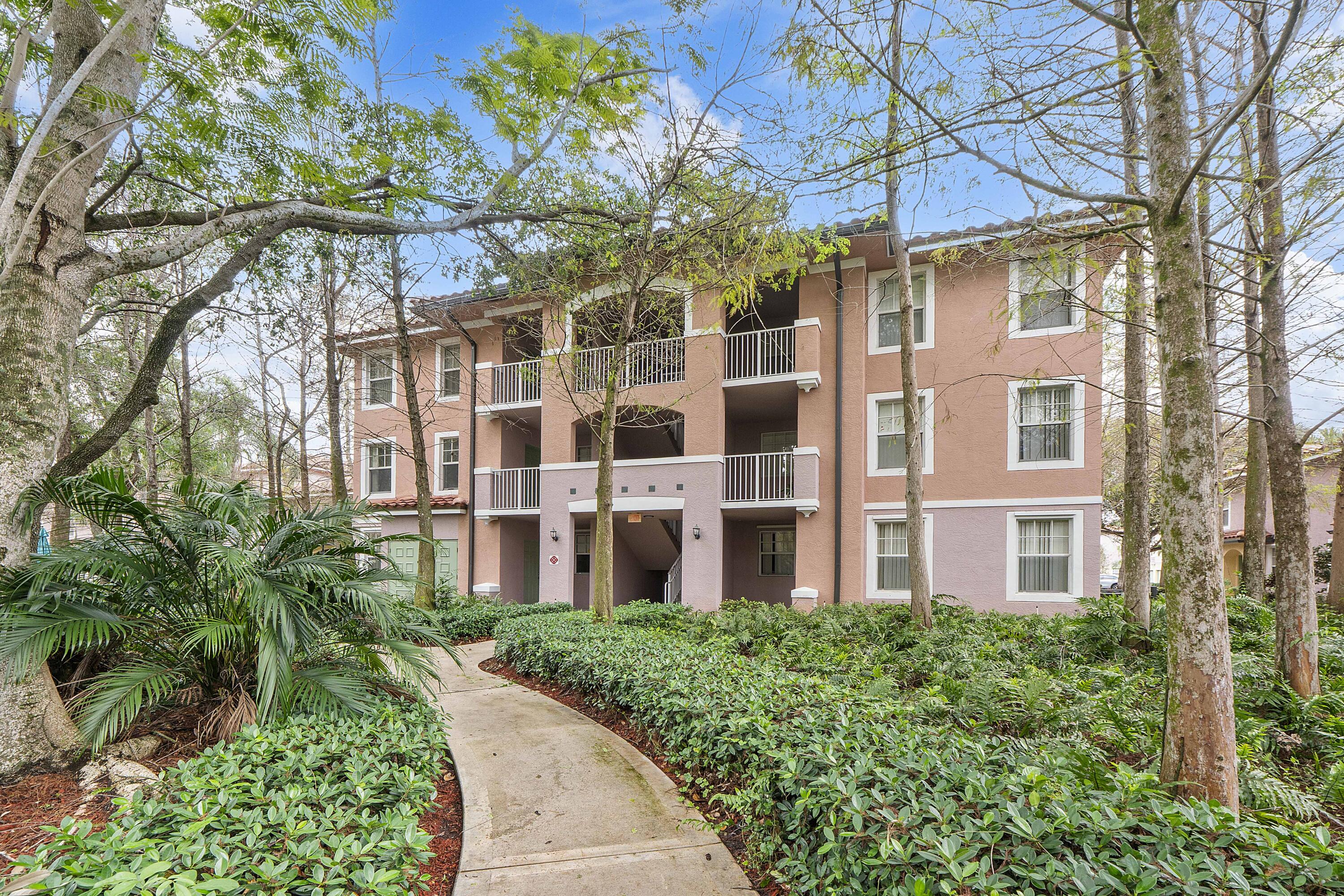 6592 West Sample Road, Unit 6592 Coral Springs, FL 33067 - Photo 3 of 42 front view of building with a tree