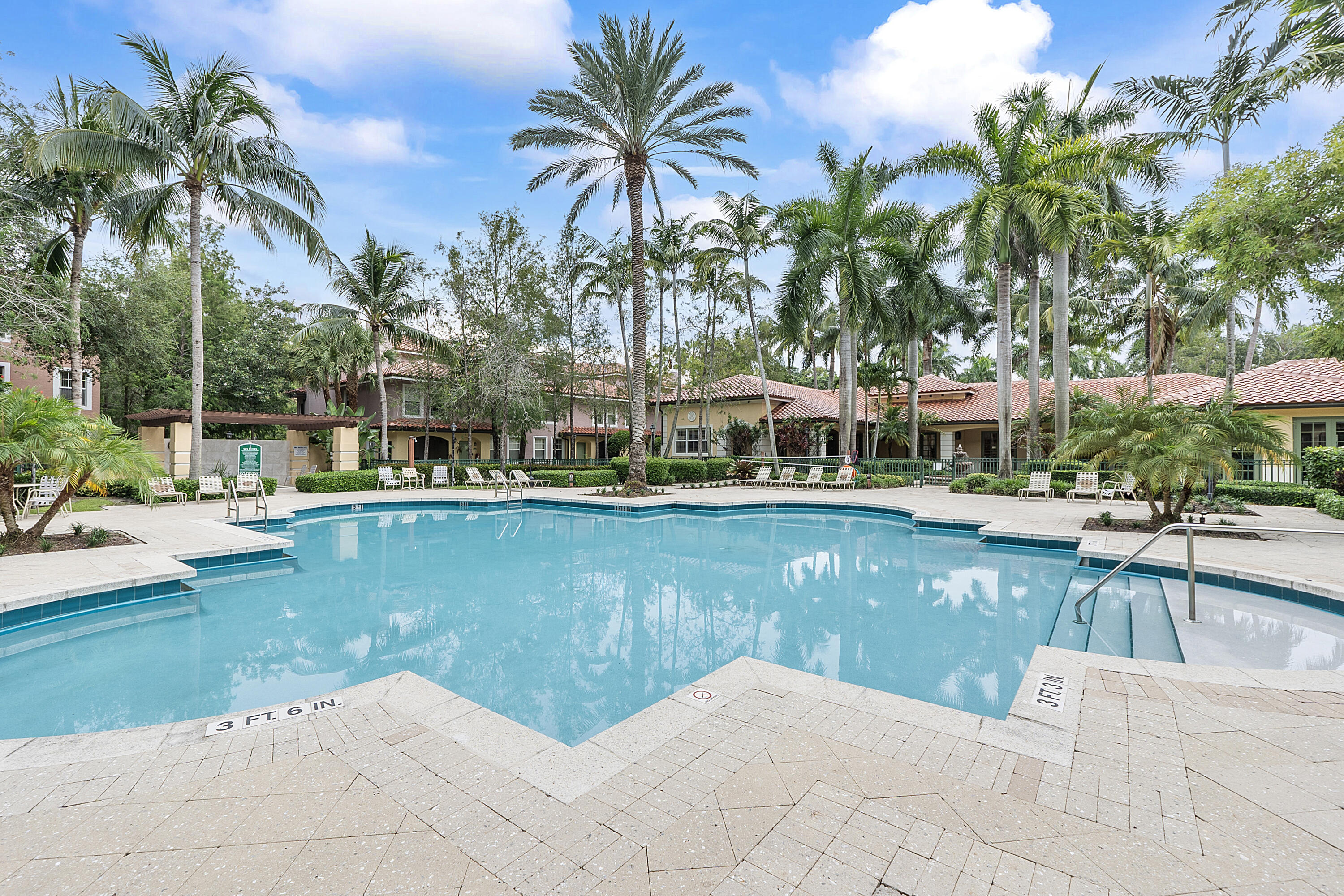 6592 West Sample Road, Unit 6592 Coral Springs, FL 33067 - Photo 34 of 42 a view of a swimming pool with a table and chairs