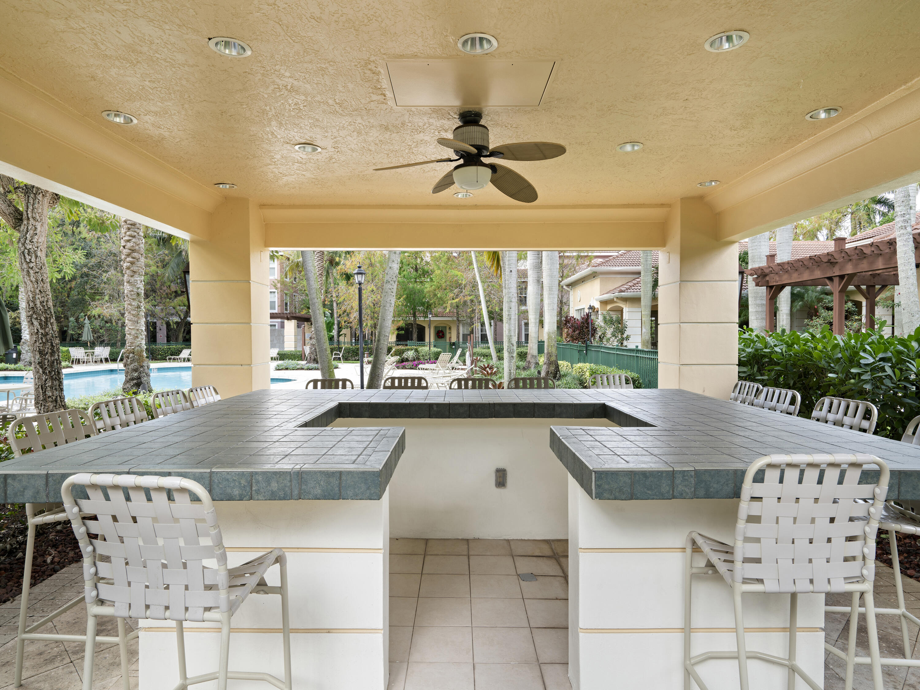 6592 West Sample Road, Unit 6592 Coral Springs, FL 33067 - Photo 38 of 42 a kitchen with a table and chairs in it