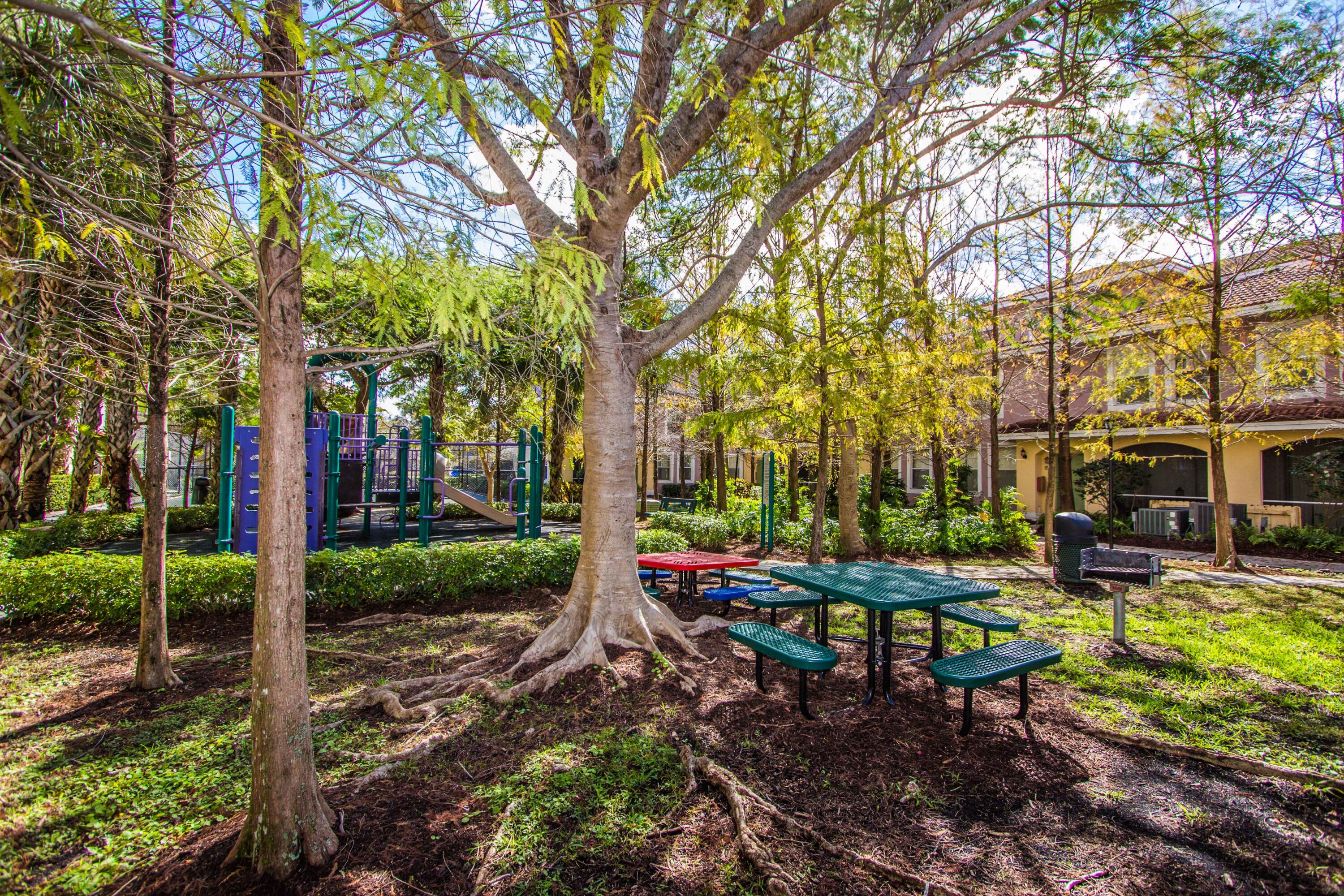 6592 West Sample Road, Unit 6592 Coral Springs, FL 33067 - Photo 40 of 42 a backyard of a house with table and chairs