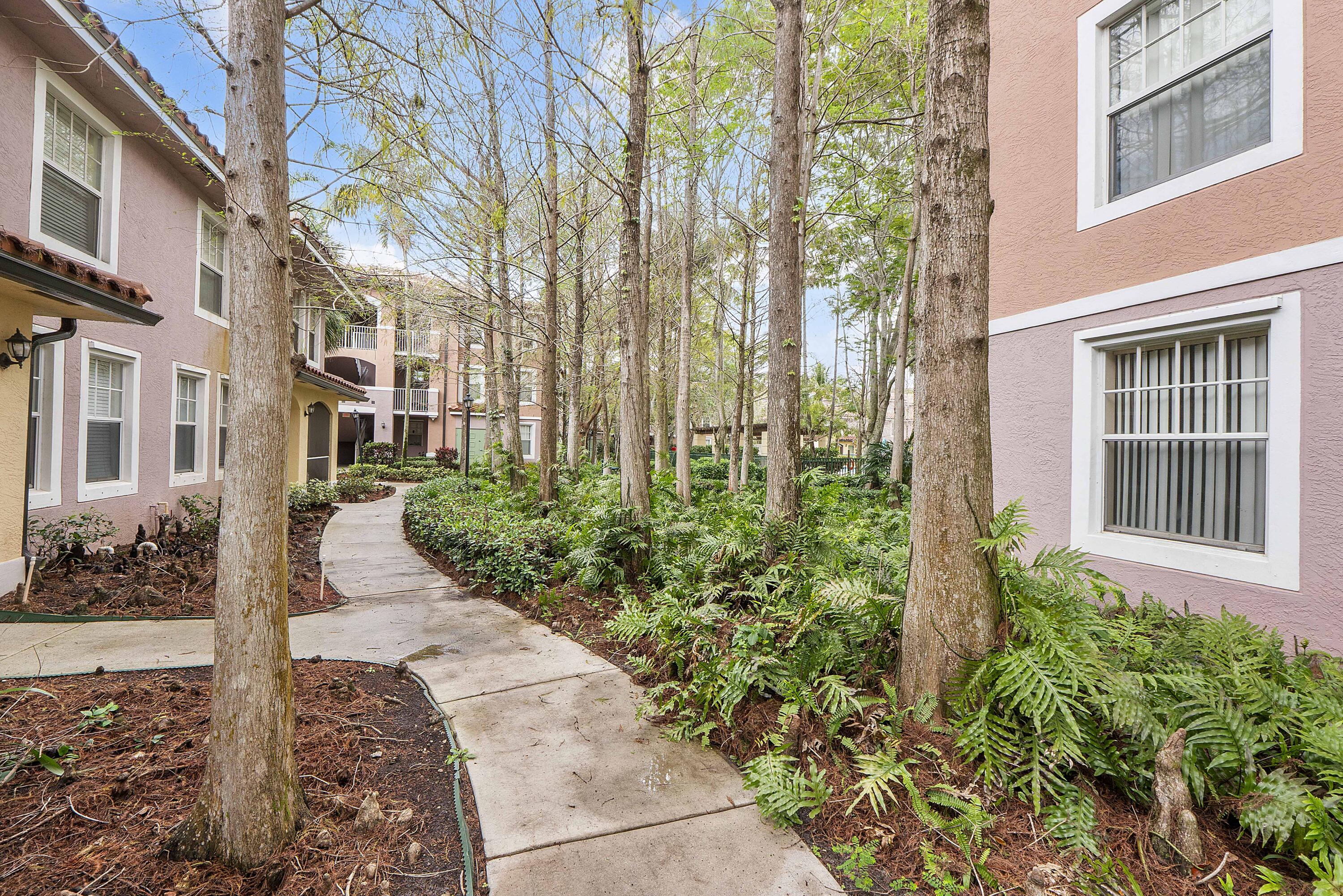 6592 West Sample Road, Unit 6592 Coral Springs, FL 33067 - Photo 4 of 42 a view of a pathway both side of the house