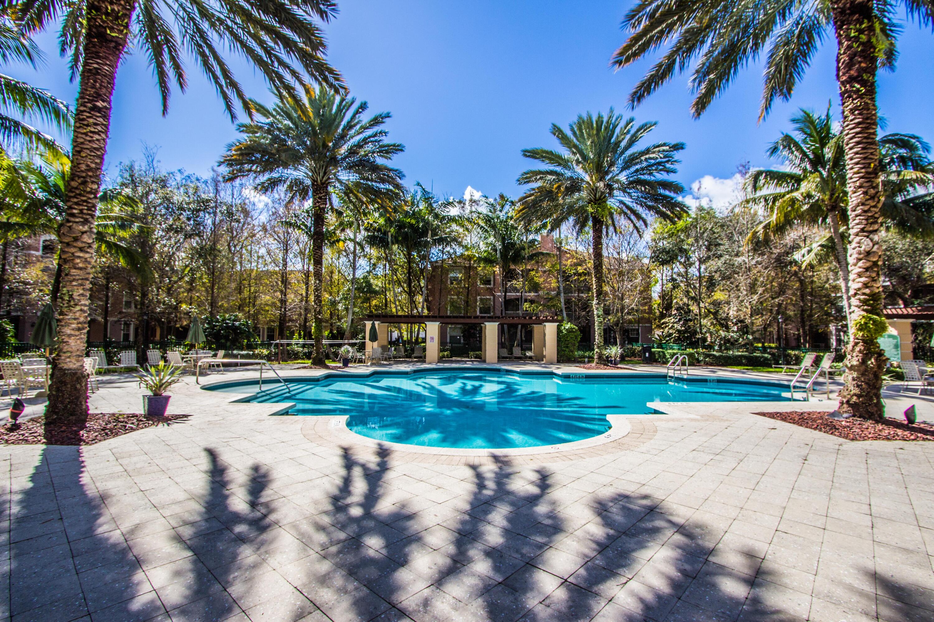 6592 West Sample Road, Unit 6592 Coral Springs, FL 33067 - Photo 5 of 42 a view of a yard and palm trees