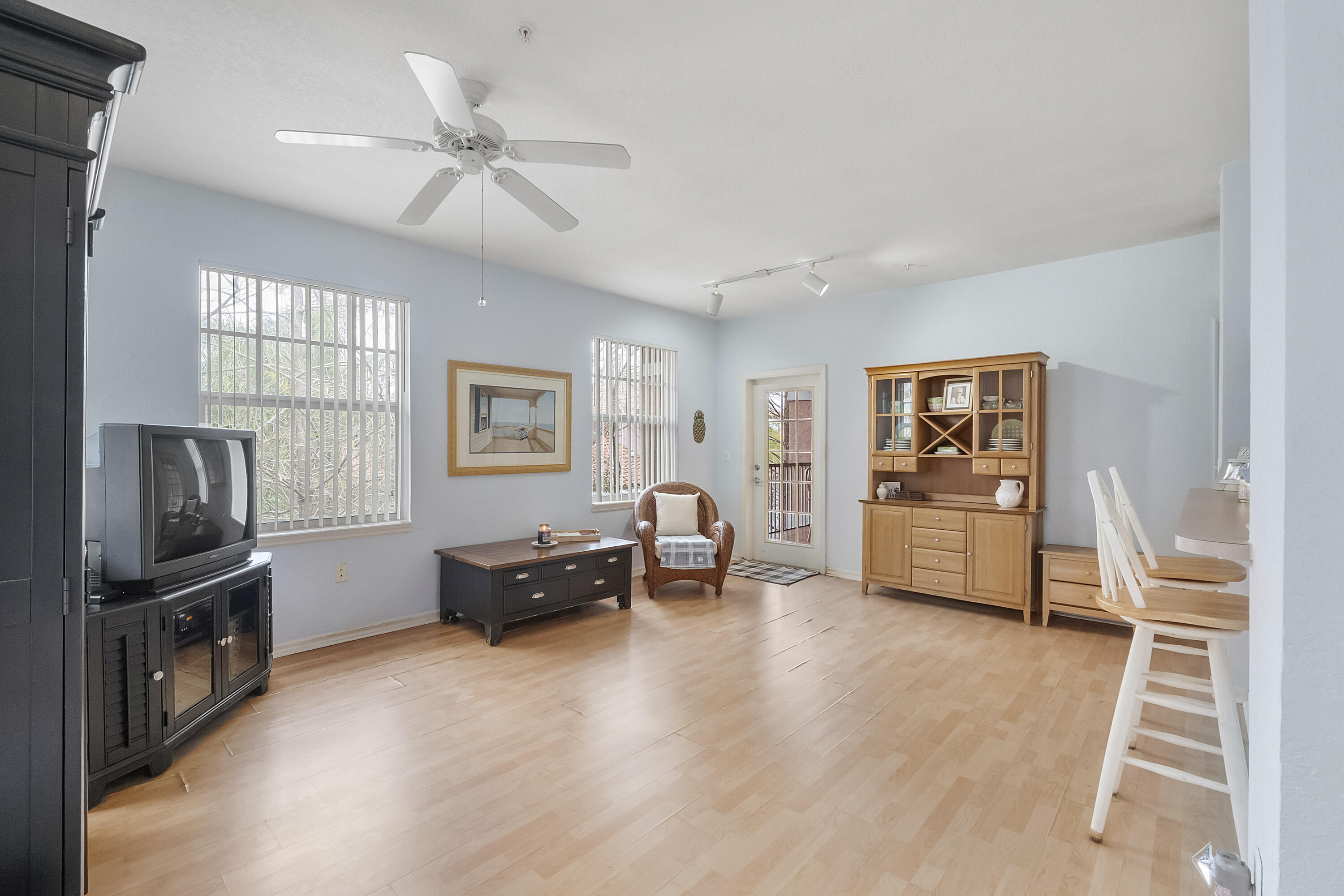 6592 West Sample Road, Unit 6592 Coral Springs, FL 33067 - Photo 9 of 42 a living room with furniture and a flat screen tv