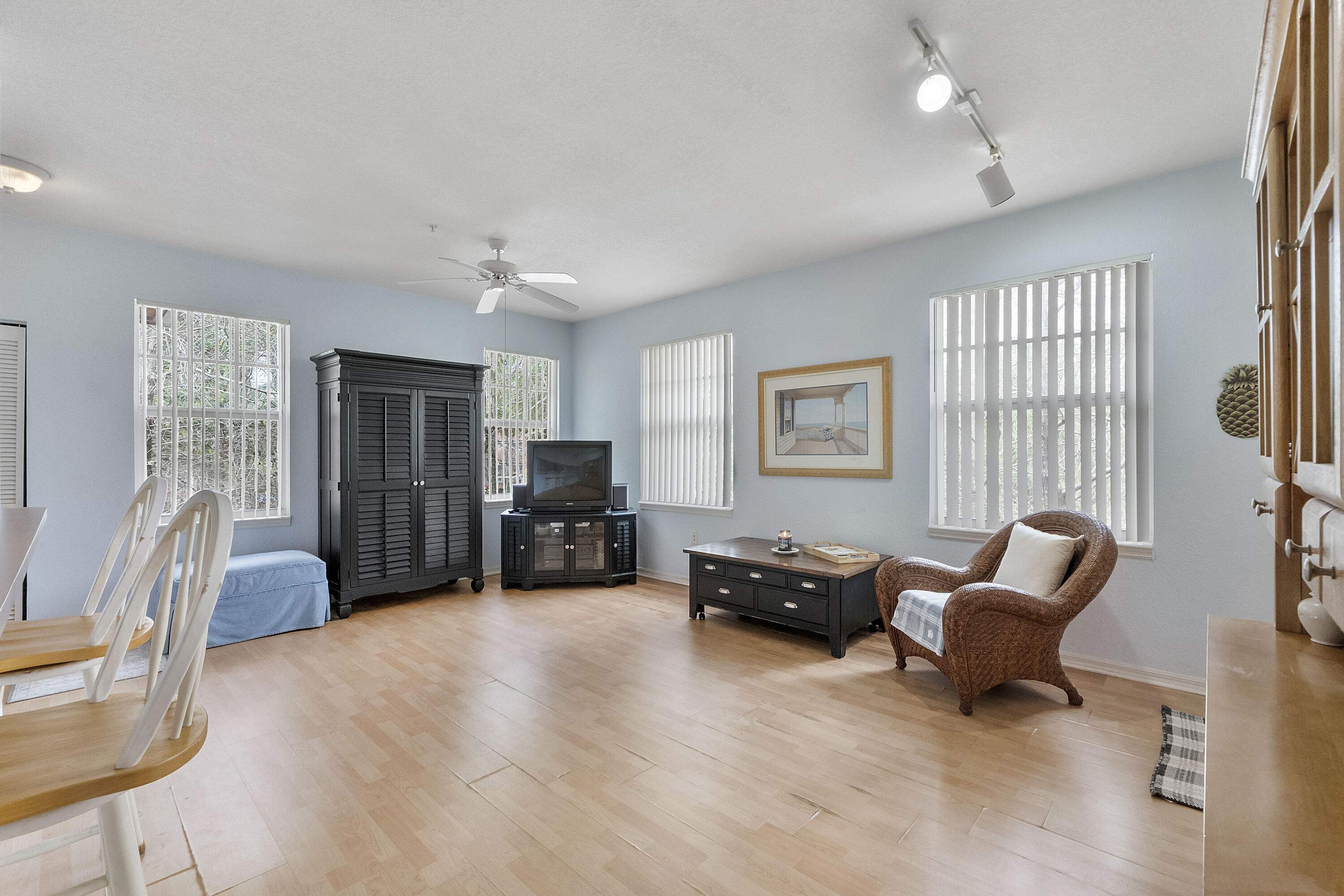 6592 West Sample Road, Unit 6592 Coral Springs, FL 33067 - Photo 10 of 42 a living room with furniture and a flat screen tv