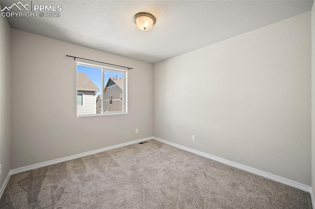 7768 Bone Crk Road Colorado Springs, CO 80924 - Photo 12 of 25 an empty room with windows