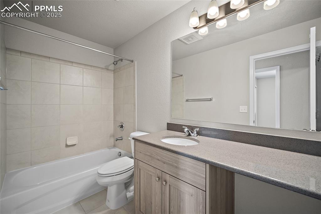 7768 Bone Crk Road Colorado Springs, CO 80924 - Photo 16 of 25 a bathroom with a sink a toilet a mirror a bathtub and shower