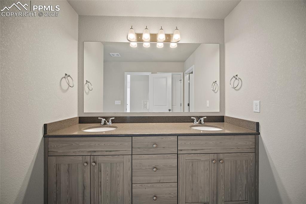 7768 Bone Crk Road Colorado Springs, CO 80924 - Photo 19 of 25 a bathroom with a sink and a mirror