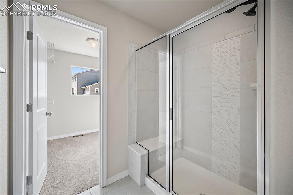 7768 Bone Crk Road Colorado Springs, CO 80924 - Photo 21 of 25 a bathroom with a glass shower door