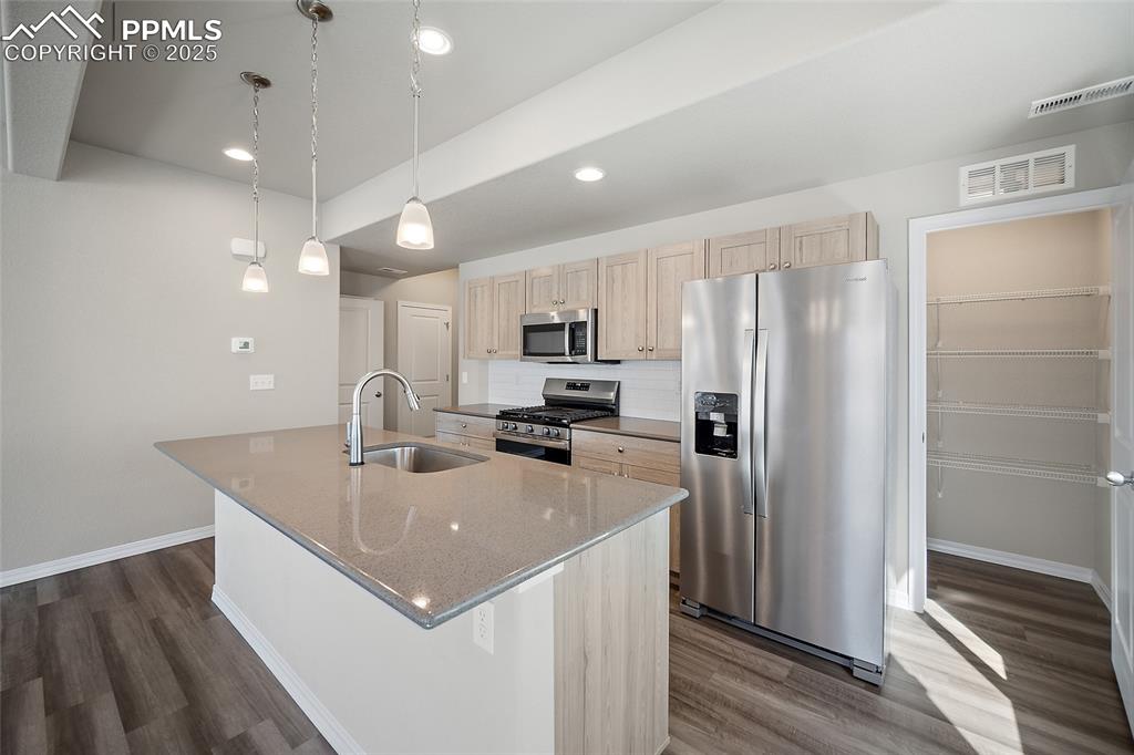 7768 Bone Crk Road Colorado Springs, CO 80924 - Photo 4 of 25 a kitchen with stainless steel appliances granite countertop a sink a refrigerator and a refrigerator